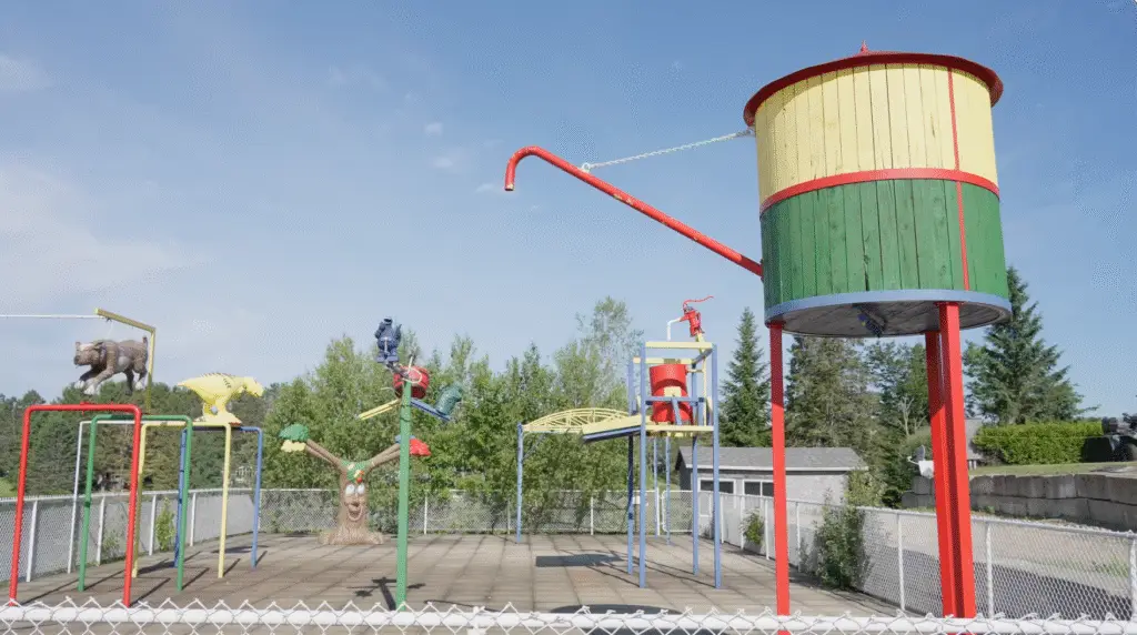 a playground with a water tower and a play set