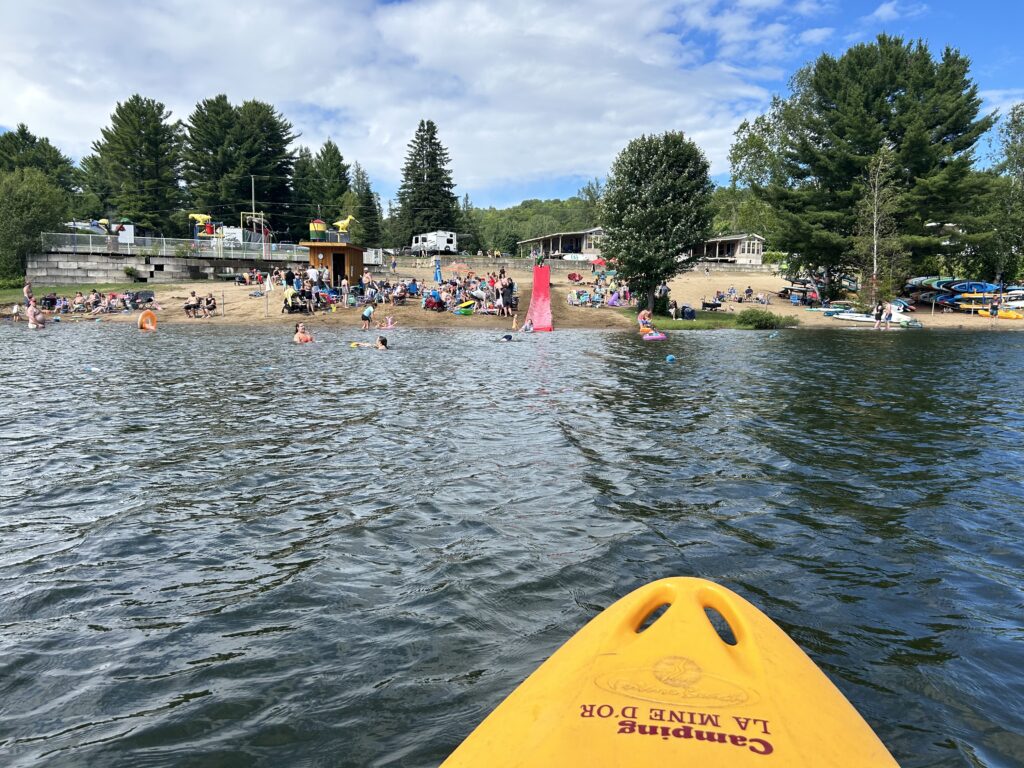 a kayak in a lake with people in the background